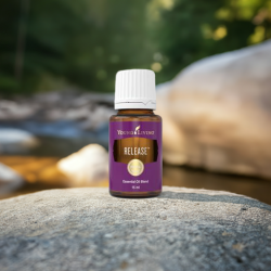 Ätherisches Öl Release von Young Living, 100 % naturrein in Braunglasflasche mit Tropfer, auf Stein in der Natur